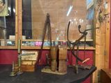 a display of old tools on a table in a room