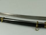 pair of two swords sitting on top of each other on a white surface