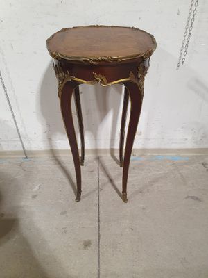 a small table that has a wooden top on it