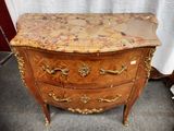 a marble top chest of drawers on display in a room
