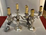 silver plated candelab with four candles on a red table cloth