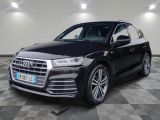 a black audi suv parked in a garage with a checkered floor