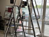 a ladder that is sitting on the floor in front of a window