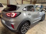 the rear end of a silver car parked in a garage