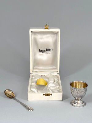 an image of a silver cup and spoon sitting next to each other