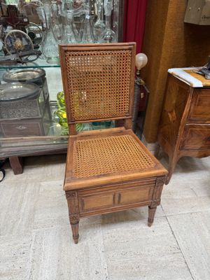a chair that is sitting in front of a glass case