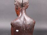 an image of a wooden sculpture of a man ' s head on a table