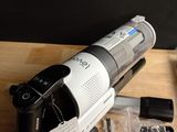 a vacuum that is sitting on a table next to other items