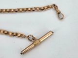 an image of a gold chain with a pen attached to it
