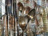a wire basket with spoons and spoons hanging from it