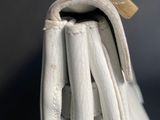 a close up of a white purse with a lock on it
