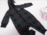 a green and red plaid onesuit next to a pair of pink shoes