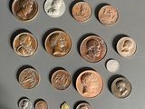 a lot of coins that are on the table