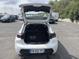 a white car with its trunk open in a parking lot