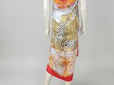 a mannequin dress with a leopard print and a red scarf