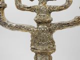 a large metal candelier with a bird on top of it