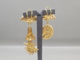 a close up of a pair of earrings on a stand
