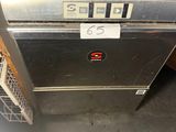 a silver oven that is sitting in a room