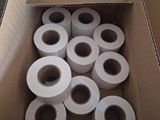 many rolls of toilet paper in a box on the ground