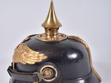 an old helmet with a golden winged decoration on it