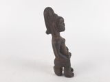 a small wooden statue of a woman holding a baby