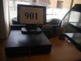 a laptop computer sitting on a desk with a clock on it