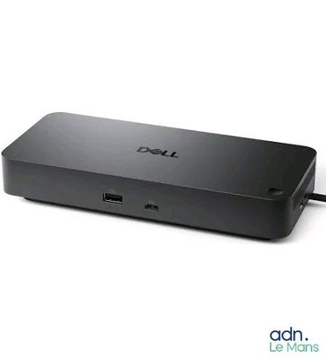 une photo d'un ordinateur portable Dell posé sur une surface blanche