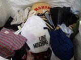 a pile of clothes and hats in a trash can