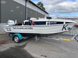 a boat that is parked on the trailer in front of a building