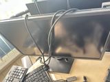 two computer monitors and a keyboard on a desk