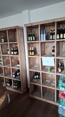 many bottles of beer on the shelves in the room