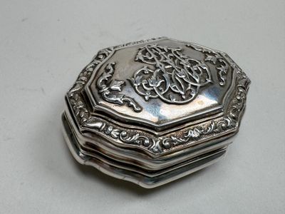 a silver box that has a design on it