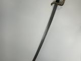 a close up of a sword on a white surface with a black handle