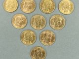 un gros plan sur un tas de pièces d'or posées sur une surface bleue