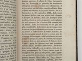an open book on a white surface with a black border