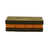 an orange and black gift box with a logo on it