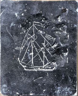 a close up of a stone with a boat on it