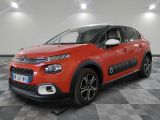 une citrole rouge garee sur un plancher en damier dans un garage