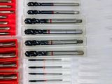 many different types of drill bits in a plastic case