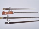 four different types of swords are displayed on a white surface