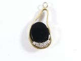 an image of a black and gold pendant with diamonds on a white background