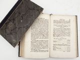an open book on a table with a bookmark on it