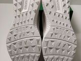 the soles of a pair of white sneakers are on a white surface