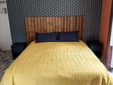 a bed that has a yellow blanket on it