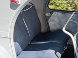a seat in the back of a car with a blue seat cover