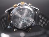 a close up of a watch on a black surface