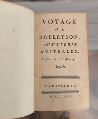 an old book that is open on a table