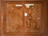 an old wooden cabinet with a lot of stickers on it