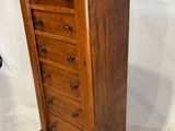 an image of a wooden chest of drawers in a room