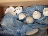 a box full of tea cups and saucers in it
